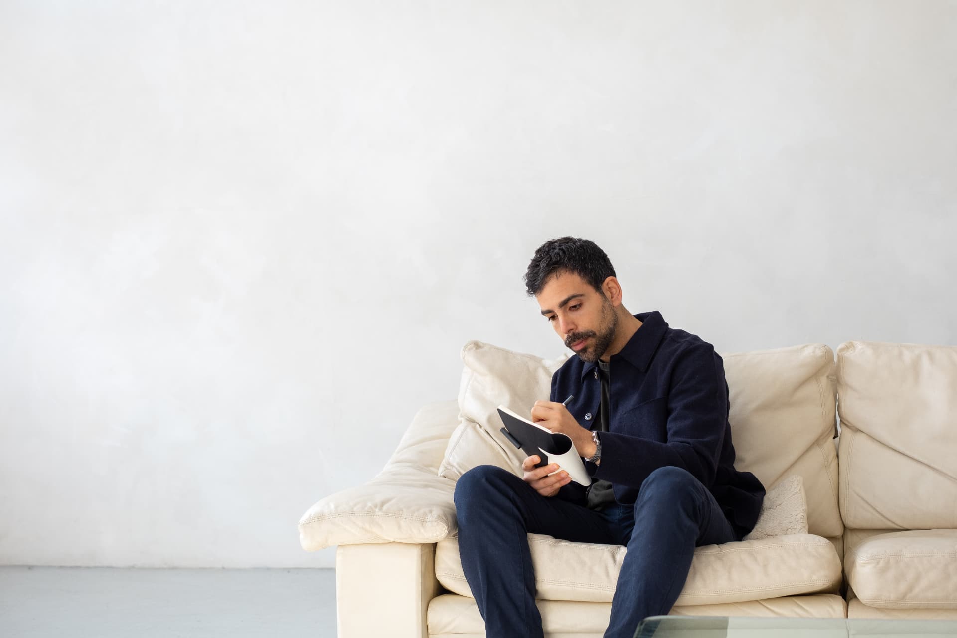 Giuseppe, online dating coach for professional men, writing in a notebook